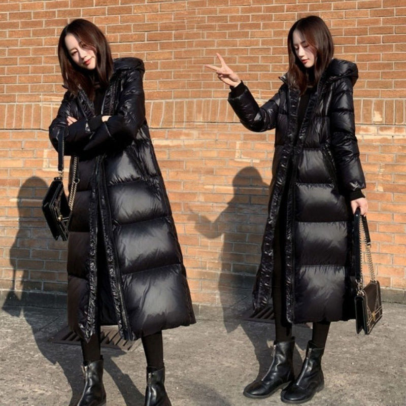 Long, tailored women's coat with shiny surface