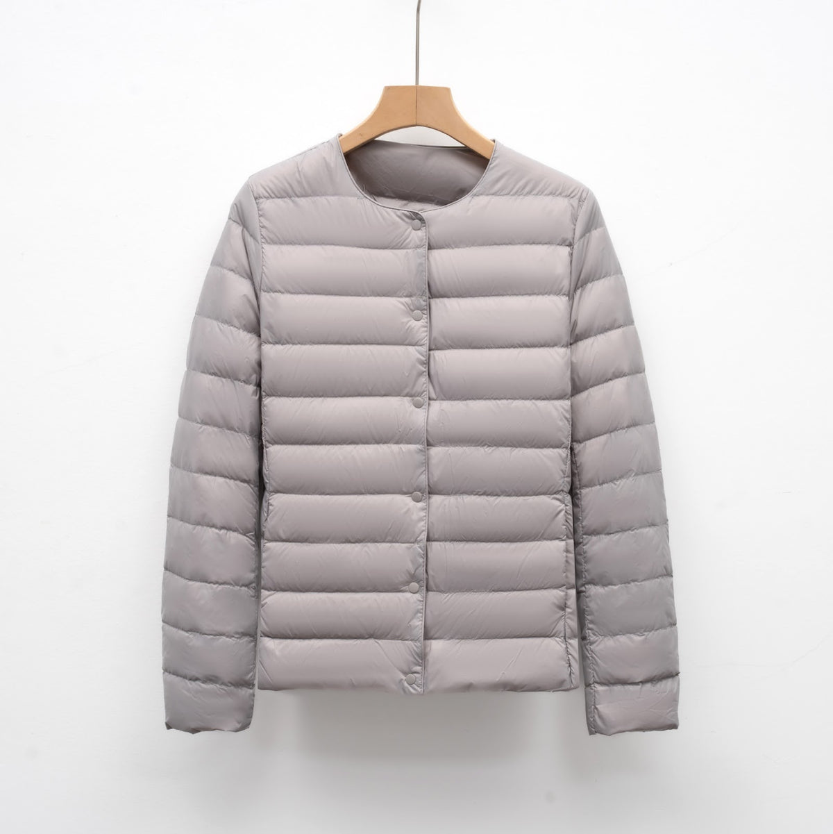 Light women's quilted jacket with round neckline