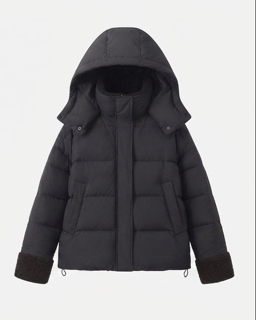 Women's short quilted travel-friendly winter parka with teddy cuffs, stowable hood, and spacious side pockets
