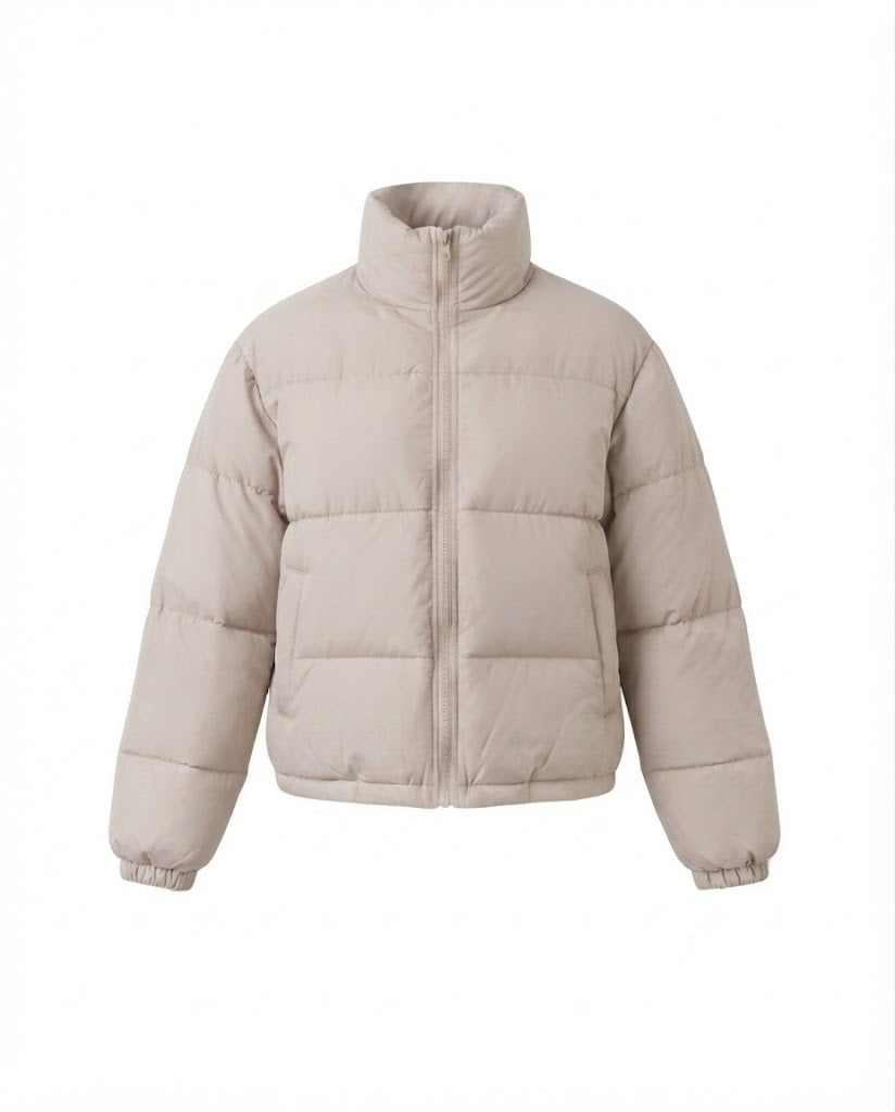 Women's short boxy travel puffer jacket with high collar, reinforced thermal lining, and elastic cuffs