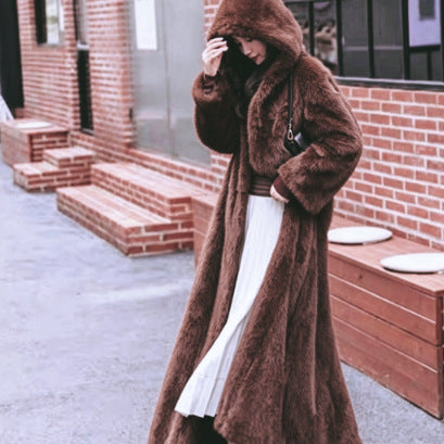 Long women's coat made of faux fur with hood