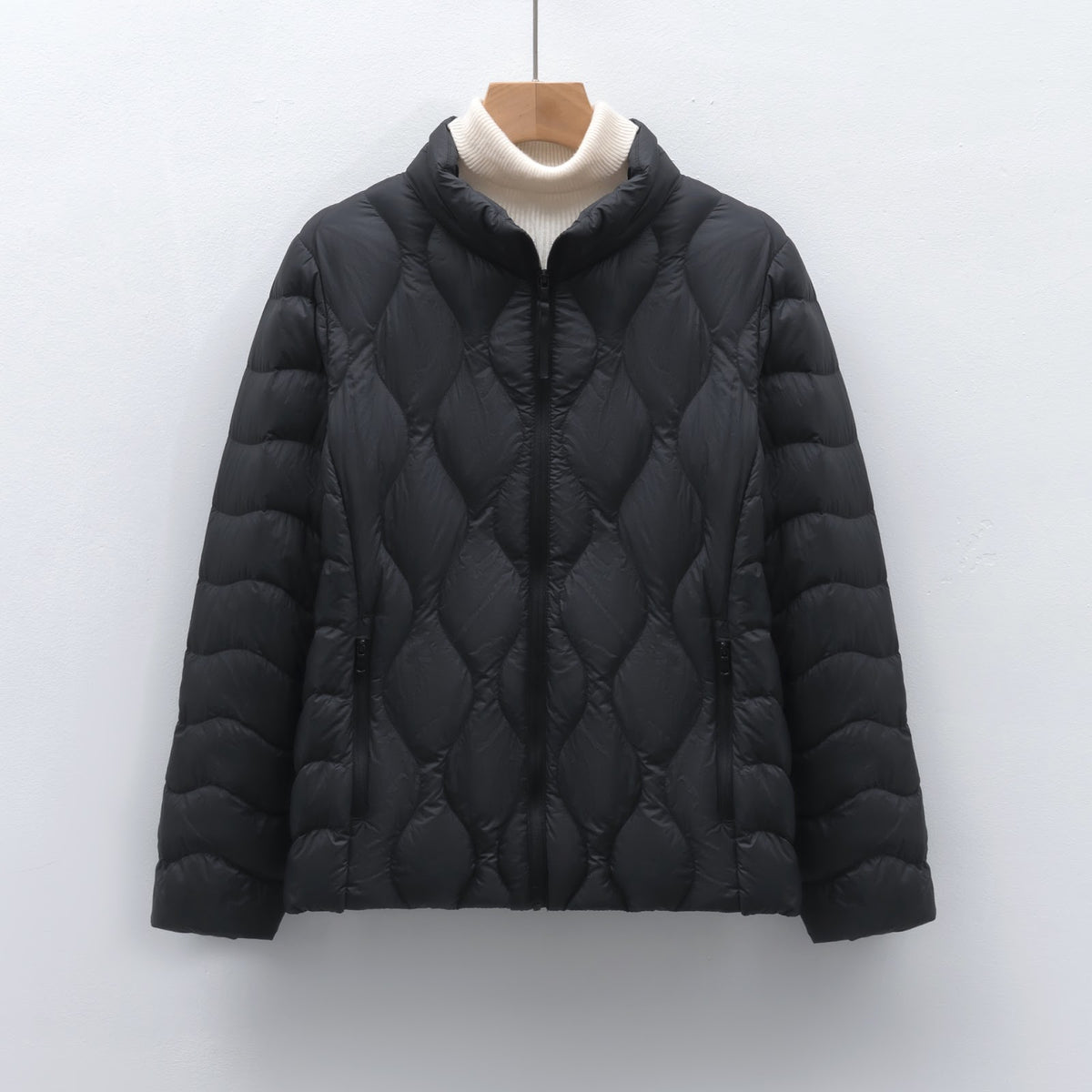 Light women's down jacket with stand-up collar and wave pattern