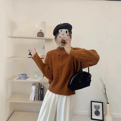 Short cable knit sweater with asymmetric neckline