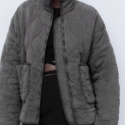 Women's quilted jacket with standing collar and tie belt
