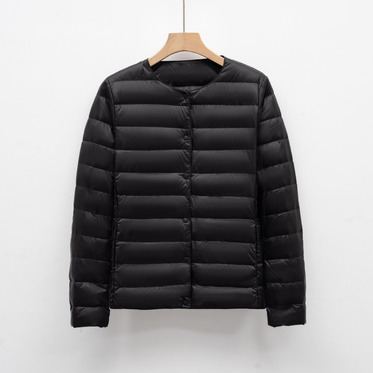 Light women's quilted jacket with round neckline