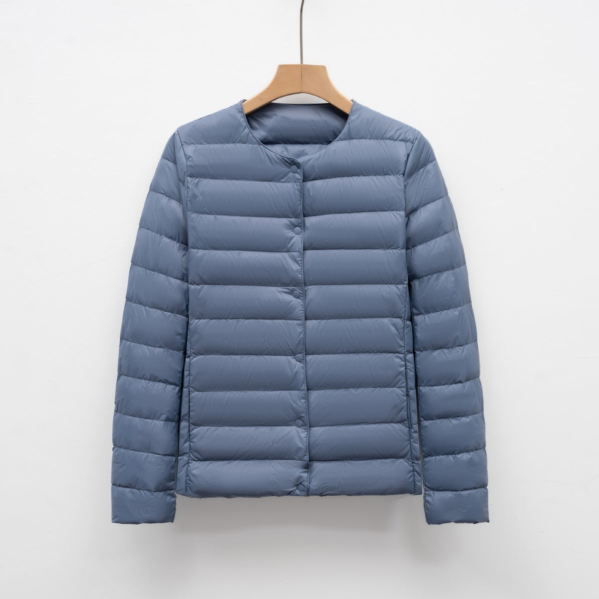 Light women's quilted jacket with round neckline