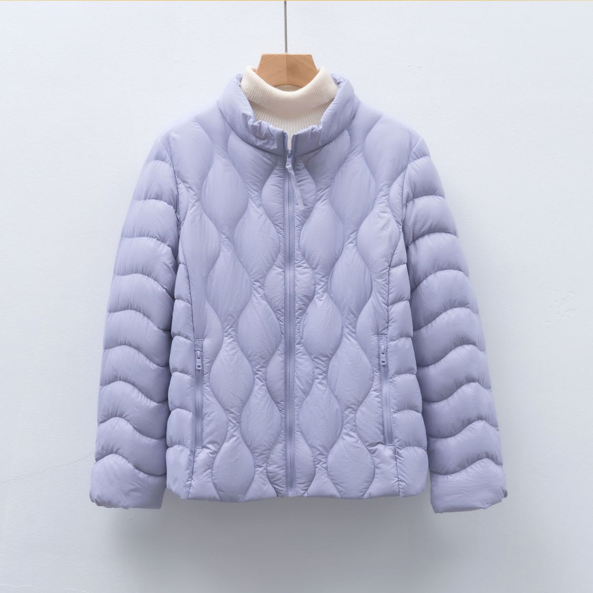 Light women's down jacket with stand-up collar and wave pattern