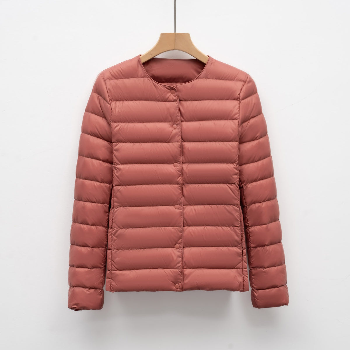 Light women's quilted jacket with round neckline