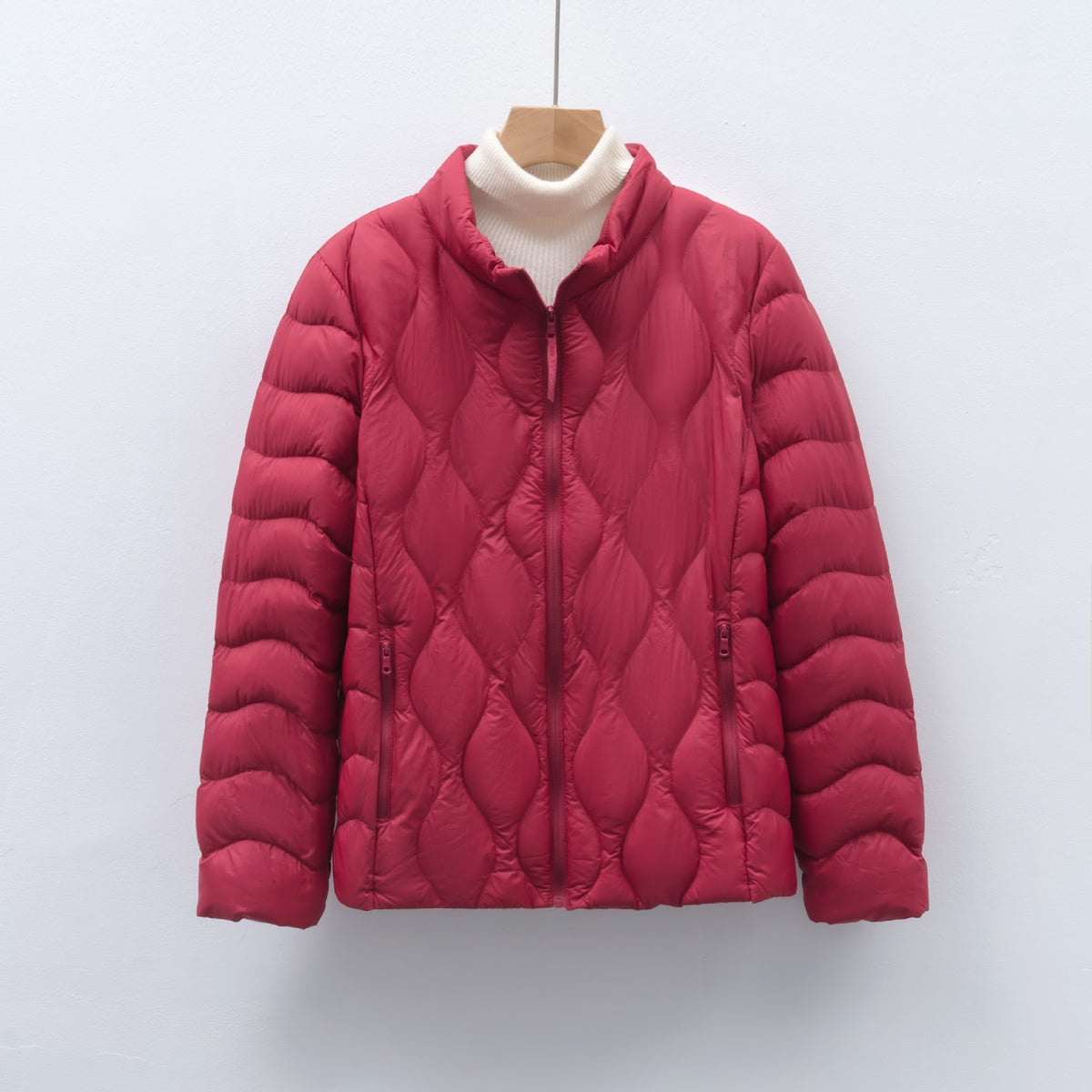 Light women's down jacket with stand-up collar and wave pattern