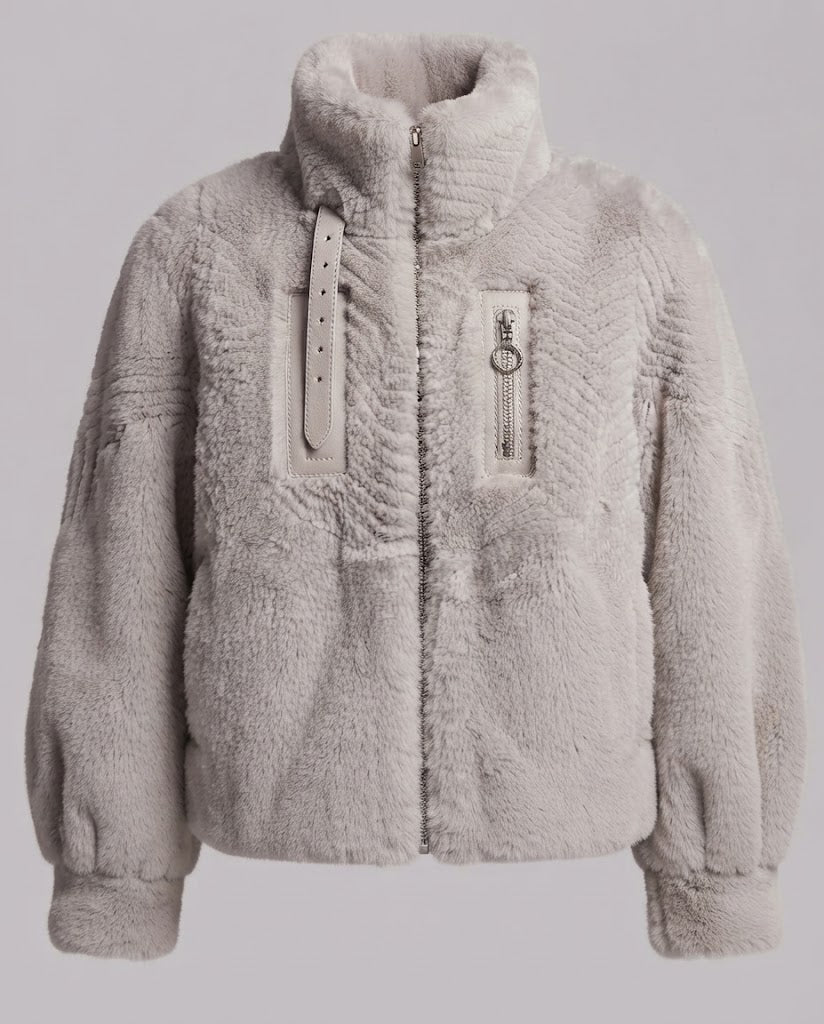 Women's cozy faux fur jacket with stand-up collar, zippered pocket and feminine balloon sleeve silhouette