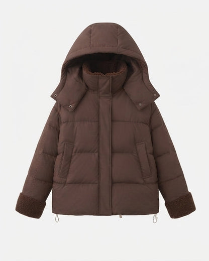 Women's short quilted travel-friendly winter parka with teddy cuffs, stowable hood, and spacious side pockets