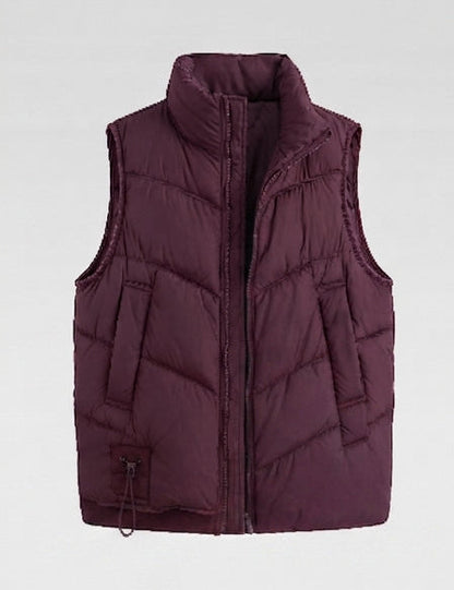 Women's non-padded quilted vest with high stand-up collar, adjustable drawstring hem, and generous flap pockets