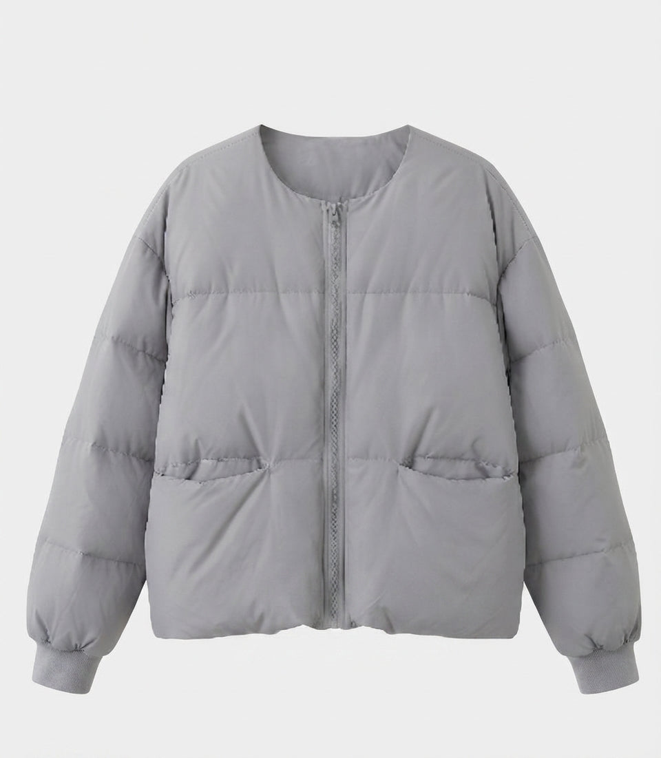 Women's short boxy quilted jacket with straight cut, concealed zipper, and elastic cuffs