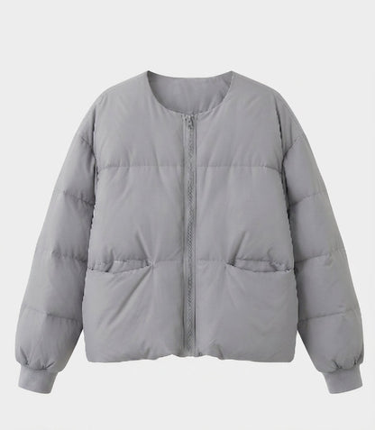 Women's short boxy quilted jacket with straight cut, concealed zipper, and elastic cuffs