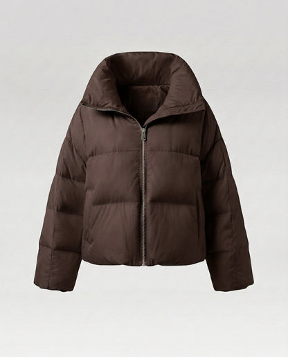 Women's cropped quilted jacket with oversized hood, lightweight thermal filling, and rounded hem