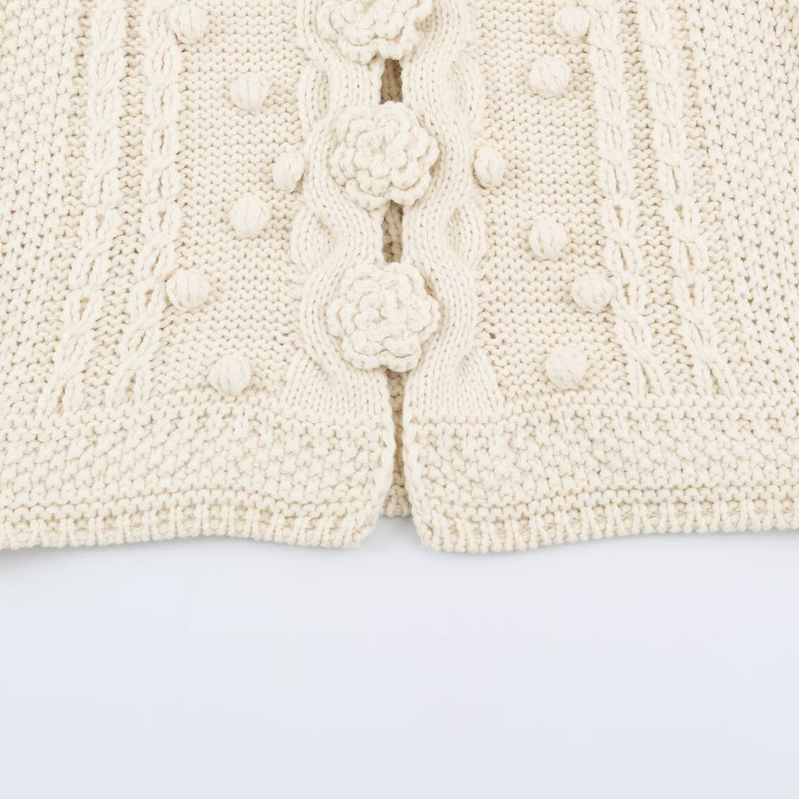 Women's knitted vest with cable pattern, flower appliqués and bobble texture EVA-US