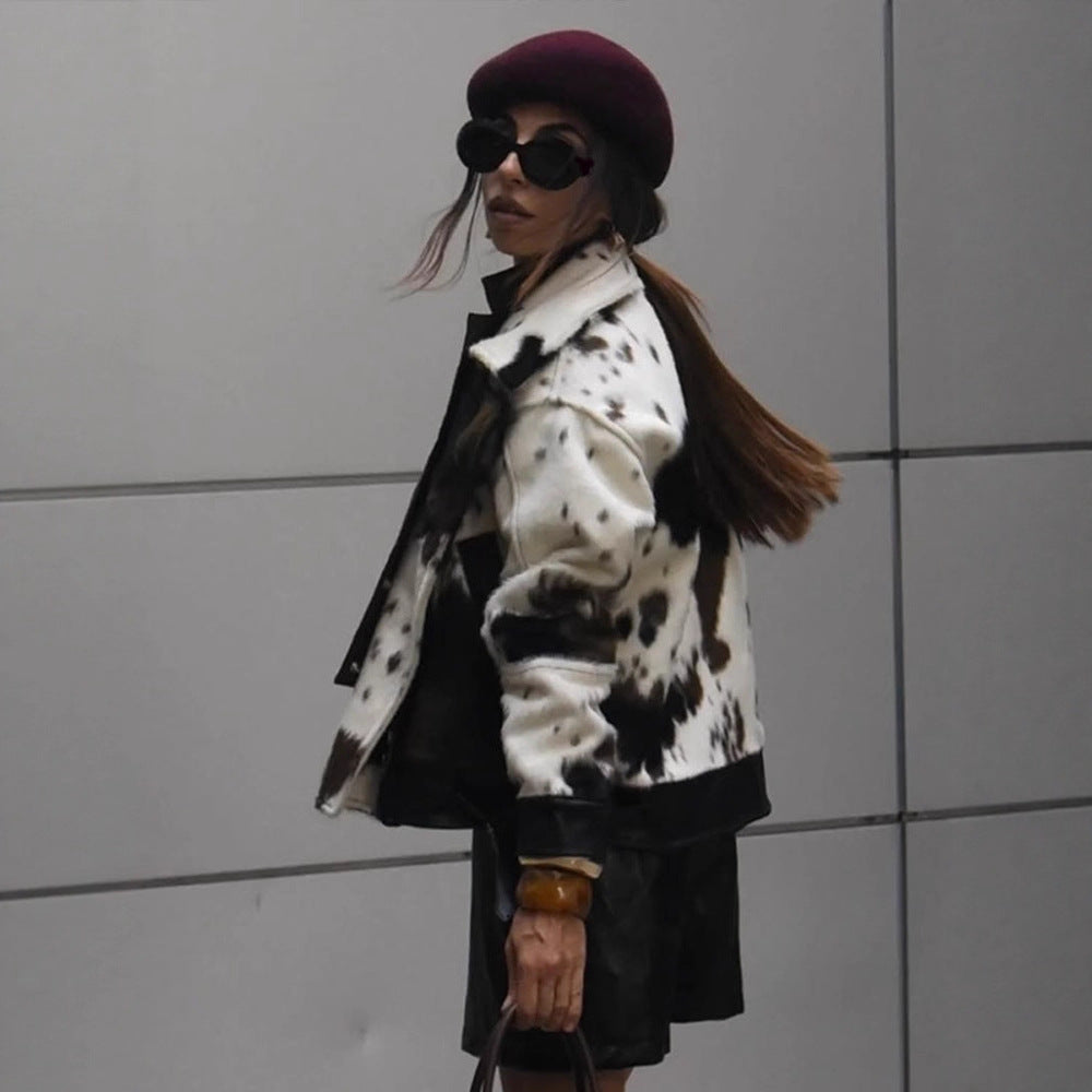 Women short padded biker jacket made of faux fur in cow print with contrast leather trim EVA-US