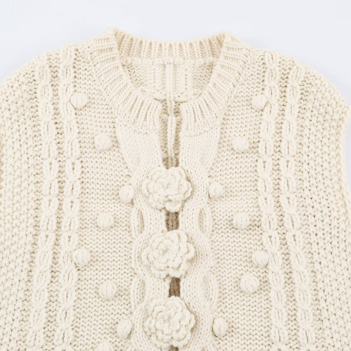 Women's knitted vest with cable pattern, flower appliqués and bobble texture EVA-US