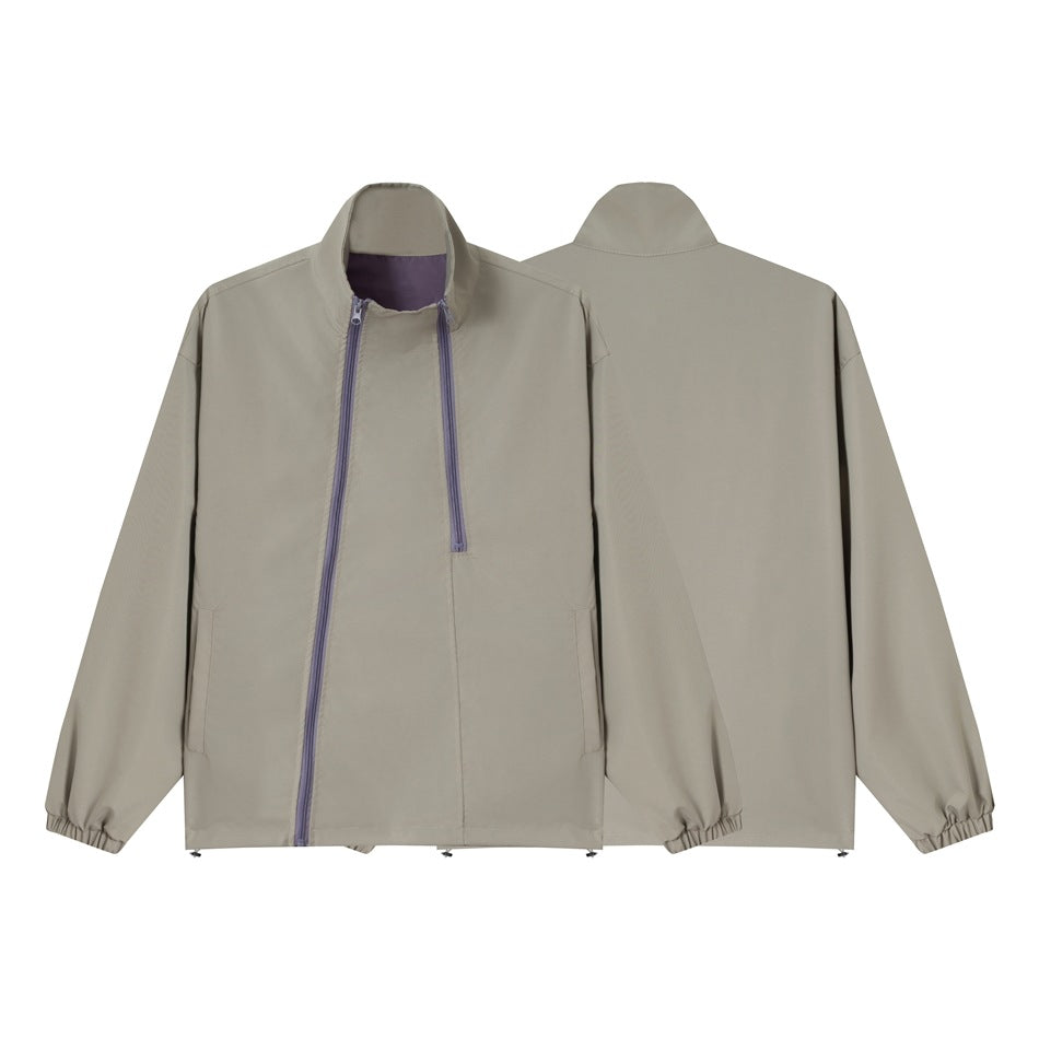 Unisex short cut technical windbreaker with asymmetric two-way zipper, detachable storm hood and shoulder mini bag EVA-US