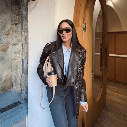 Women's Short Studded Biker Jacket Made of Faux Leather with Waist Belt EVA-US