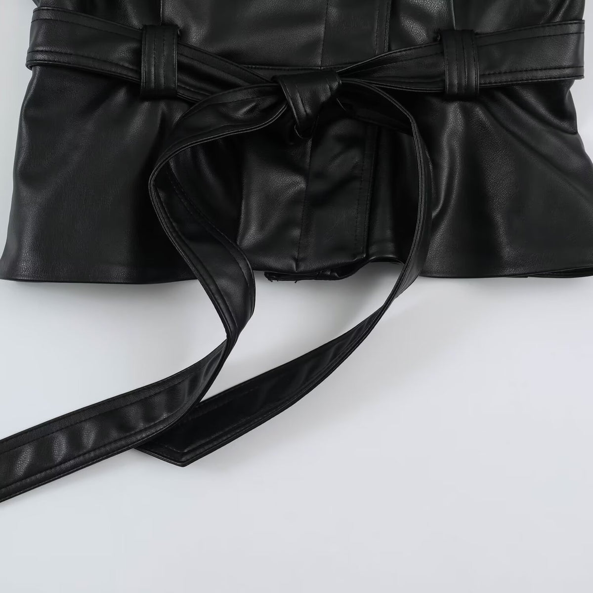 Women’s short jacket made of faux leather with a waist belt and oversized sleeves EVA-US