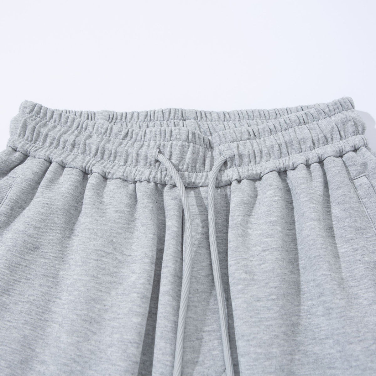 Unisex Wide French-Terry Sweatpants with elastic drawstring waistband, side pockets, and adjustable hem