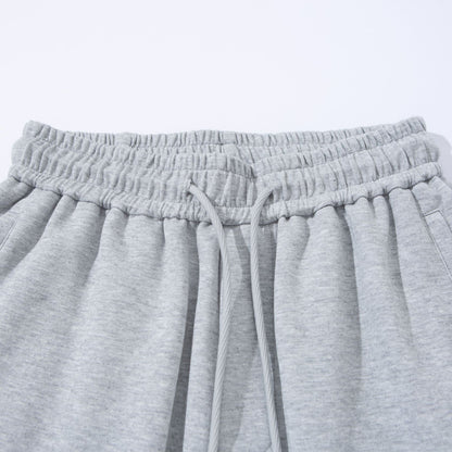 Unisex Wide French-Terry Sweatpants with elastic drawstring waistband, side pockets, and adjustable hem