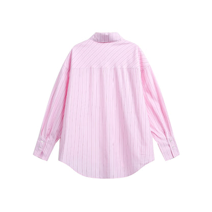 Women's oversized shirt blouse with fine pinstripe texture and rounded hem.