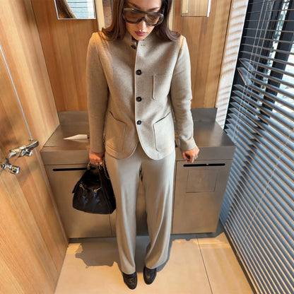 Women's tailored jacket blazer made of wool mix with stand-up collar, curved hem, and patch pockets.