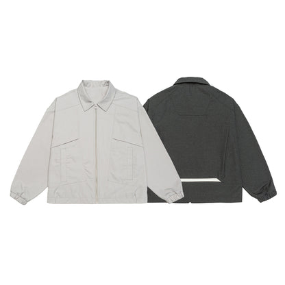 Unisex short jacket in boxy cut with shirt collar, visible metal zipper and utility patch pockets EVA-US