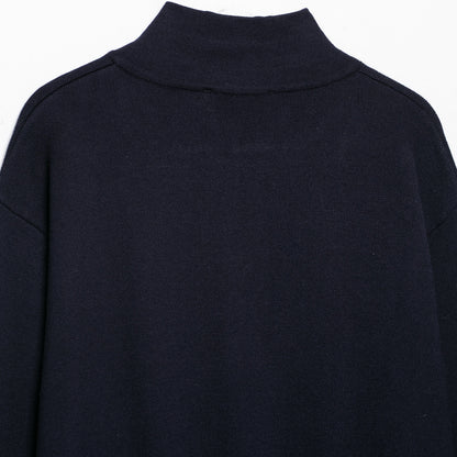 Women's cropped fine-knit cardigan with standing collar, full-length zipper, and fitted ribbed section.