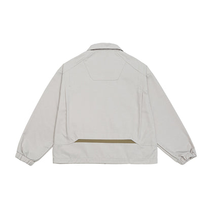 Unisex short jacket in boxy cut with shirt collar, visible metal zipper and utility patch pockets EVA-US