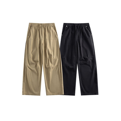 Women's wide utility-style culotte pants with elastic waistband, drawstring, and patch pockets.