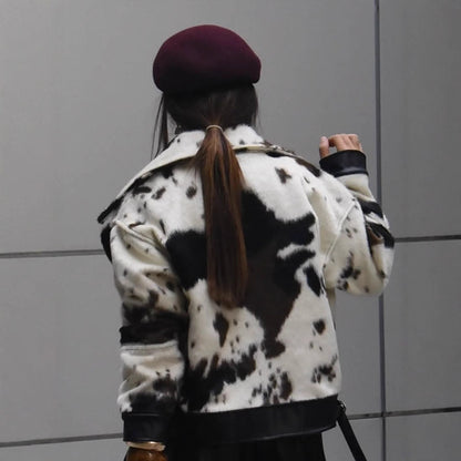 Women short padded biker jacket made of faux fur in cow print with contrast leather trim EVA-US