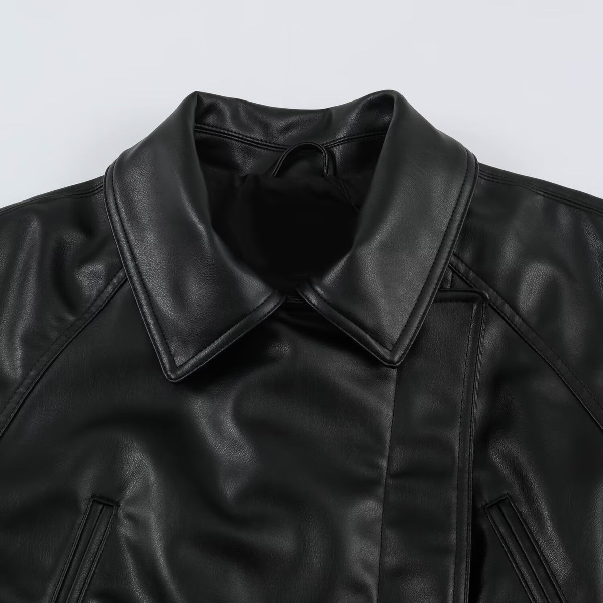 Women’s short jacket made of faux leather with a waist belt and oversized sleeves EVA-US