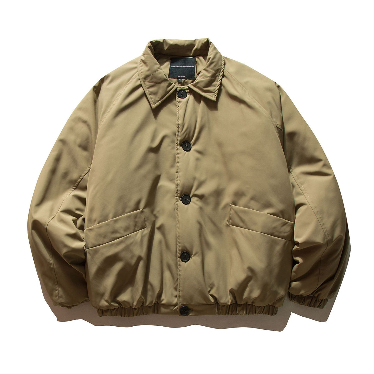 Men's short padded jacket with raglan sleeves, large flap pockets, and elastic hem EVA-US
