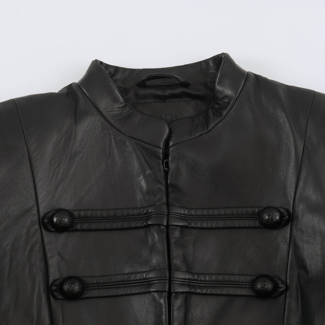 Women tailored military-inspired leather jacket with stand-up collar, decorative strap and button placket EVA-US