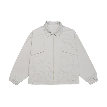 Unisex short jacket in boxy cut with shirt collar, visible metal zipper and utility patch pockets EVA-US