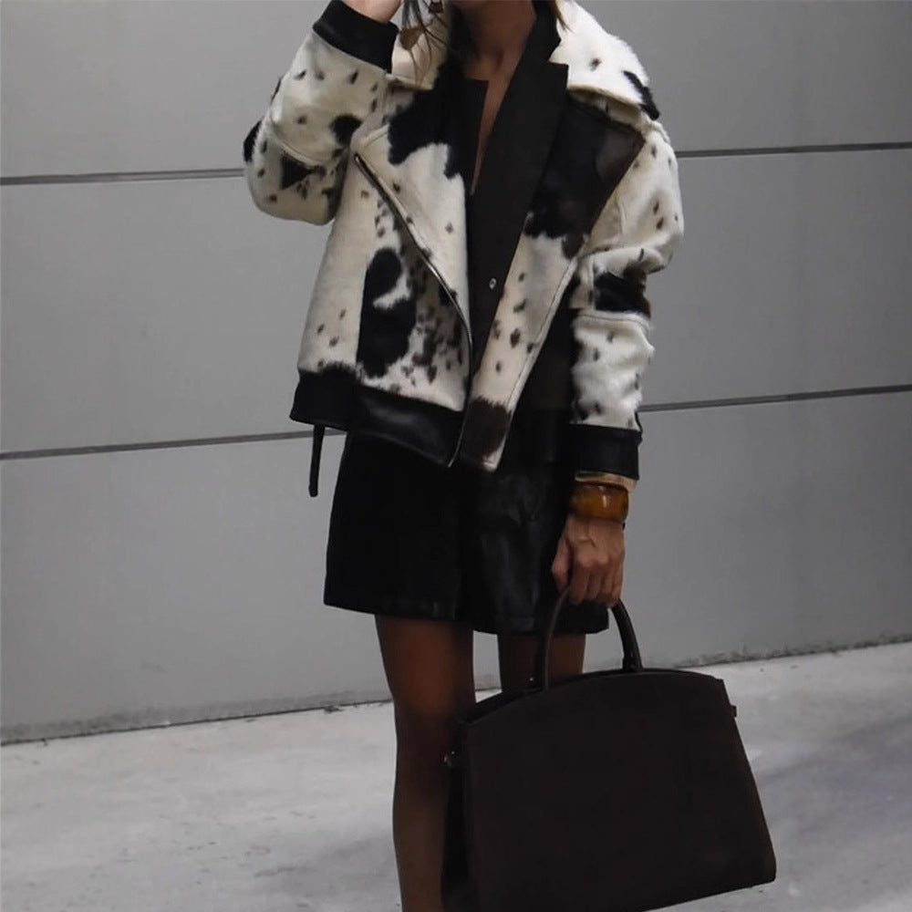 Women short padded biker jacket made of faux fur in cow print with contrast leather trim EVA-US