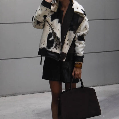 Women short padded biker jacket made of faux fur in cow print with contrast leather trim EVA-US