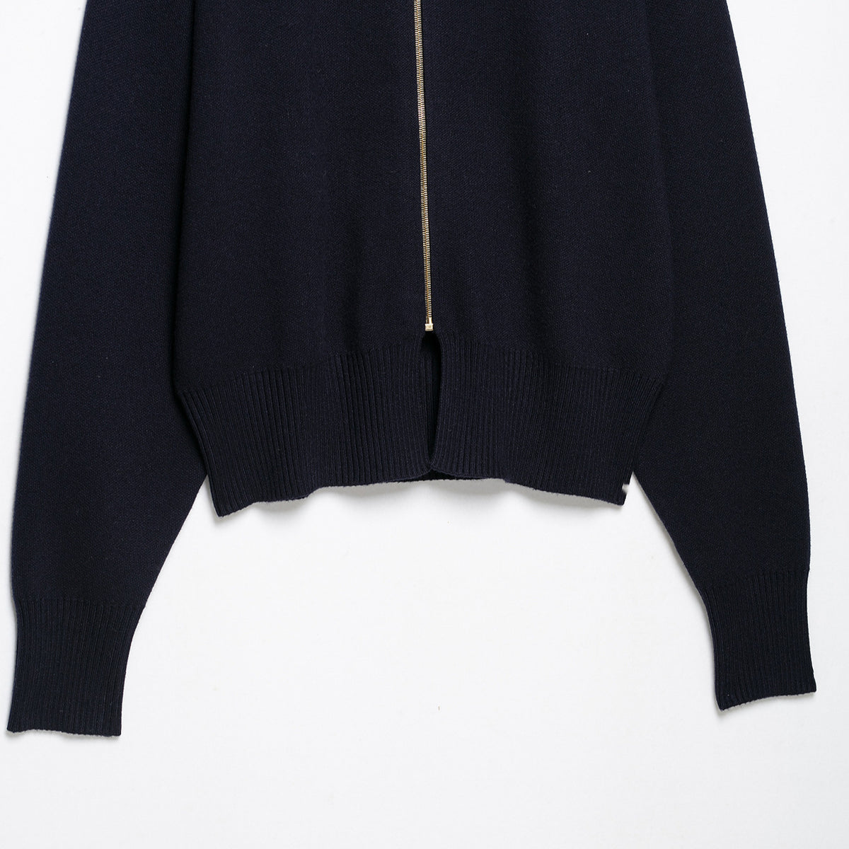 Women's cropped fine-knit cardigan with standing collar, full-length zipper, and fitted ribbed section.