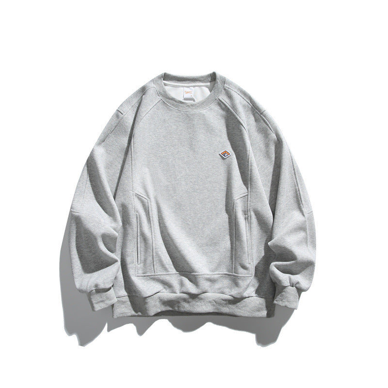 Unisex Oversize Sweatshirt made of French Terry with raglan sleeves, concealed side pockets, and a small logo patch EVA-US