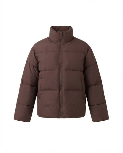 Women's short boxy travel puffer jacket with high collar, reinforced thermal lining, and elastic cuffs