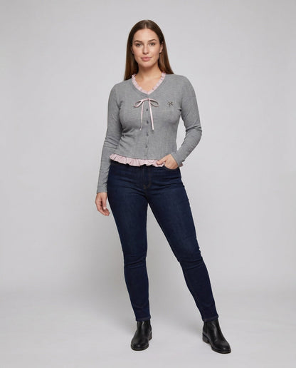 Women's long sleeve blouse with playful ruffled hem and decorative loop design - Chichicherry